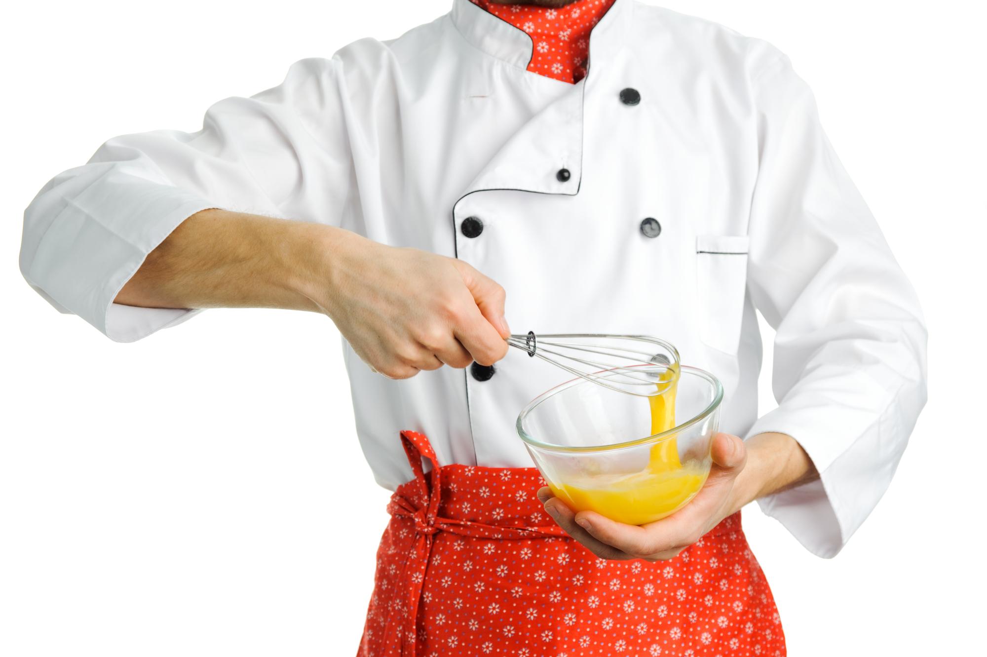 Instructor preparing a dish in a bright kitchen